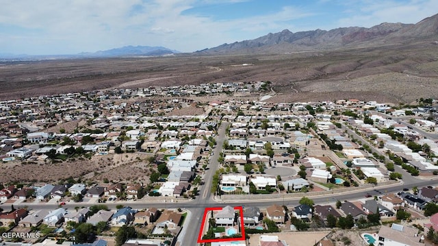 drone / aerial view featuring a residential view and a mountain view