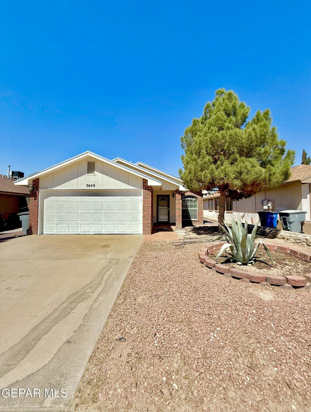 3609 Yellow Rose St, El Paso, TX 79936 - ranch-style home featuring an attached garage, concrete driveway, and brick siding