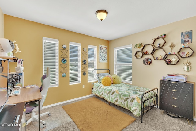 bedroom featuring baseboards, multiple windows, and carpet
