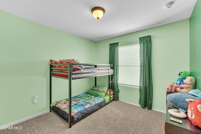 carpeted bedroom featuring baseboards