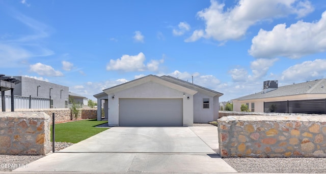 single story home featuring a garage, a front lawn, fence, stucco siding, and driveway