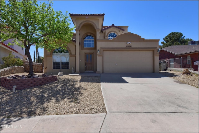 view of front of home with concrete driveway, stucco siding, and a garage