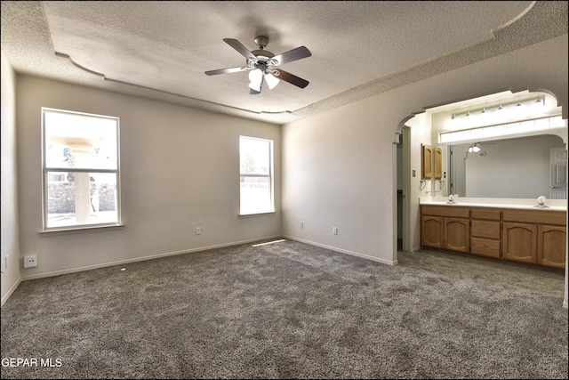 unfurnished bedroom with carpet flooring and a textured ceiling