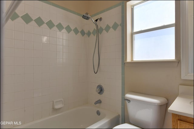 bathroom featuring toilet, vanity, and shower / tub combination