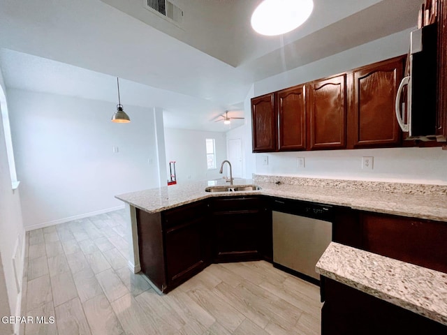 kitchen with visible vents, light stone countertops, dishwasher, a sink, and a peninsula