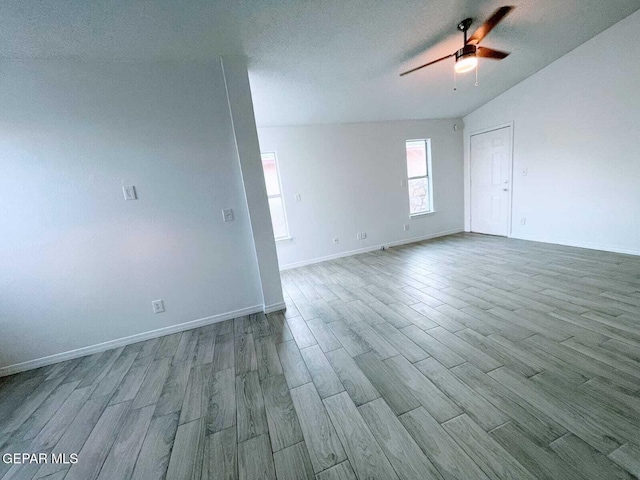 unfurnished room with baseboards, ceiling fan, and wood finished floors