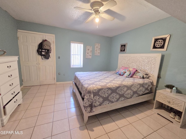 306 SW A St SW, Fabens, TX 79838 - bedroom with light tile patterned floors, a ceiling fan, and a textured ceiling