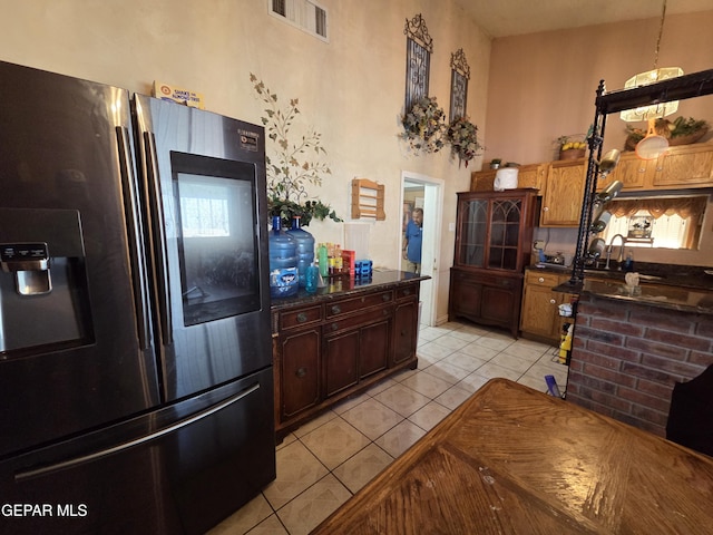 306 SW A St SW, Fabens, TX 79838 - kitchen with visible vents, light tile patterned flooring, dark countertops, stainless steel fridge, and a sink