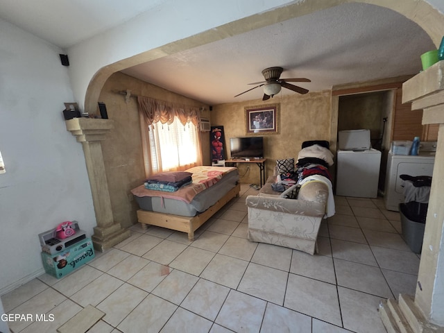 306 SW A St SW, Fabens, TX 79838 - bedroom featuring ceiling fan, light tile patterned floors, vaulted ceiling, and washing machine and clothes dryer