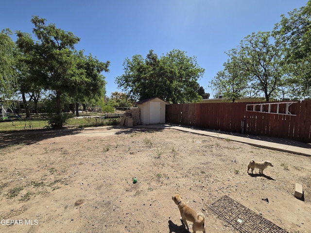 306 SW A St SW, Fabens, TX 79838 - view of yard featuring fence, an outdoor structure, and a storage unit