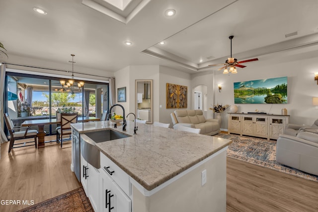kitchen featuring a sink, light wood-type flooring, recessed lighting, and open floor plan
