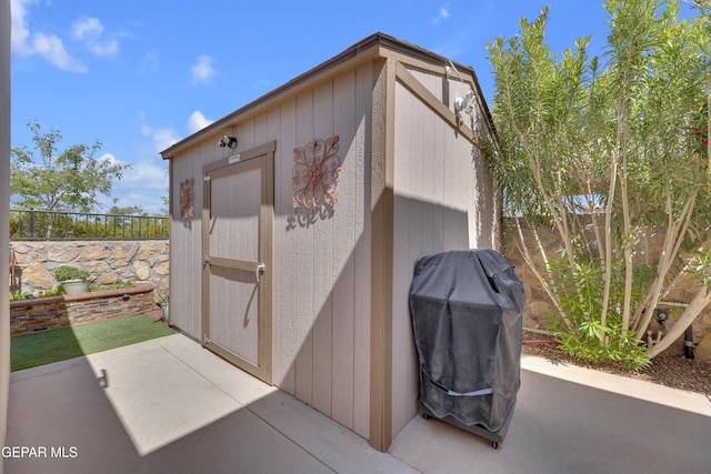 view of shed with fence
