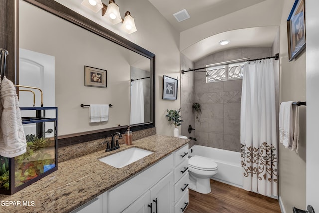 bathroom featuring shower / bath combo, vanity, toilet, wood finished floors, and visible vents