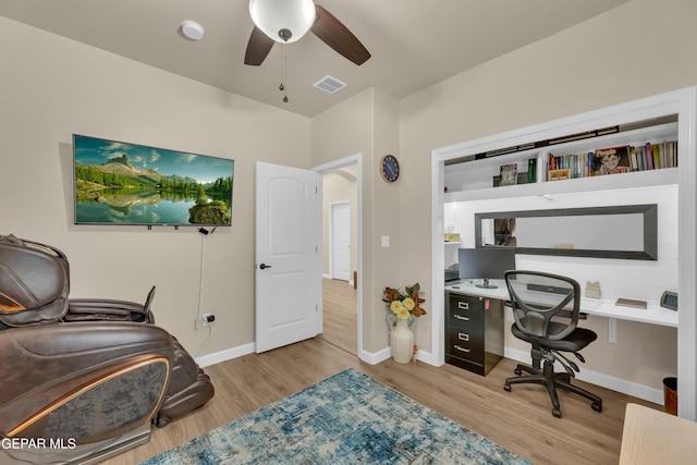 office space featuring baseboards, ceiling fan, wood finished floors, and visible vents