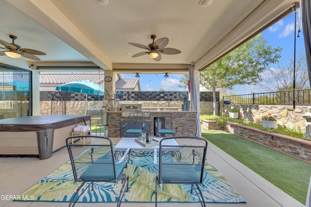 view of patio / terrace with a fenced backyard, a ceiling fan, a hot tub, and grilling area