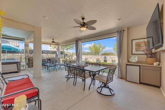 interior space with fence, a ceiling fan, and outdoor dining space