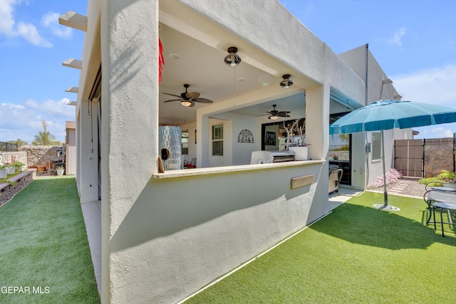 view of patio with an outdoor bar, ceiling fan, and fence private yard