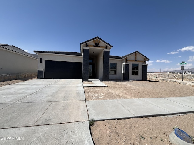321 Merced Ct, El Paso, TX 79932 - view of front facade with an attached garage, stucco siding, and driveway