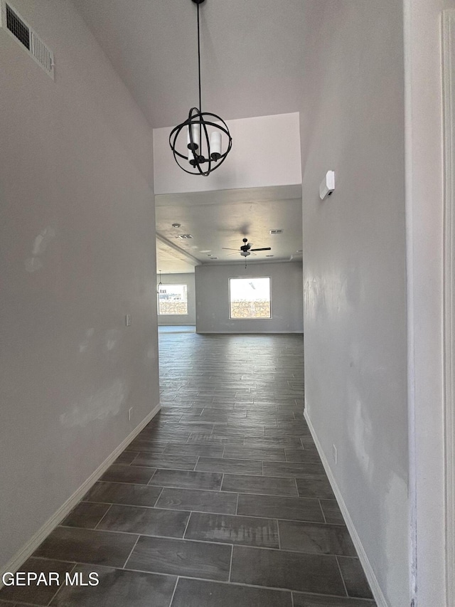 321 Merced Ct, El Paso, TX 79932 - hall featuring baseboards, wood finish floors, a notable chandelier, and visible vents