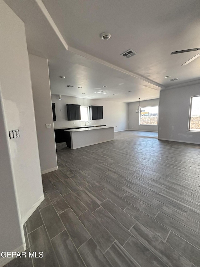 321 Merced Ct, El Paso, TX 79932 - unfurnished living room featuring visible vents, a ceiling fan, baseboards, and dark wood-style floors