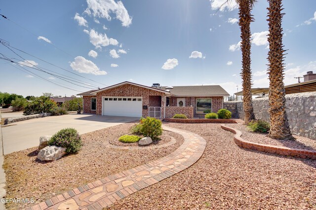 98 Northwind Dr, El Paso, TX 79912 - ranch-style house with brick siding, a garage, concrete driveway, and fence