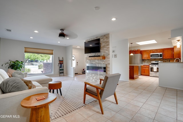 98 Northwind Dr, El Paso, TX 79912 - living area featuring a ceiling fan, light tile patterned floors, a fireplace, recessed lighting, and baseboards