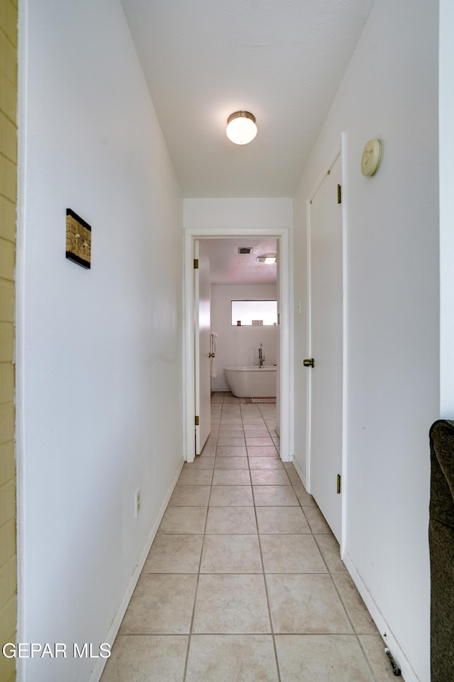 98 Northwind Dr, El Paso, TX 79912 - corridor with light tile patterned floors