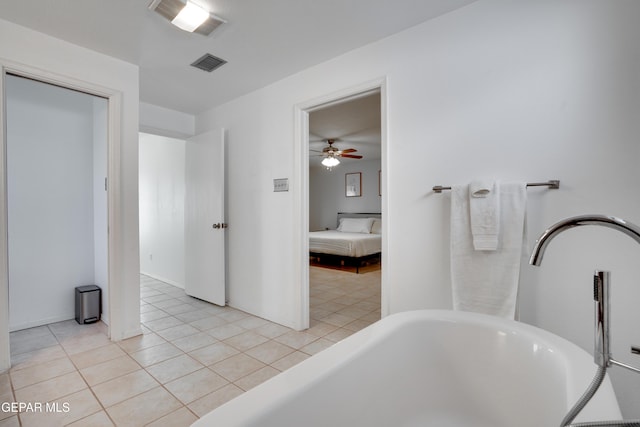 98 Northwind Dr, El Paso, TX 79912 - ensuite bathroom featuring a soaking tub, tile patterned floors, ceiling fan, and baseboards