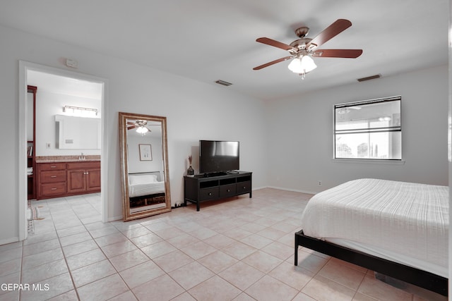 98 Northwind Dr, El Paso, TX 79912 - bedroom featuring light tile patterned flooring, connected bathroom, a ceiling fan, and a sink