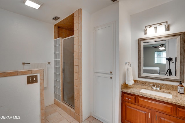 98 Northwind Dr, El Paso, TX 79912 - ensuite bathroom featuring tile patterned flooring, a shower stall, and vanity