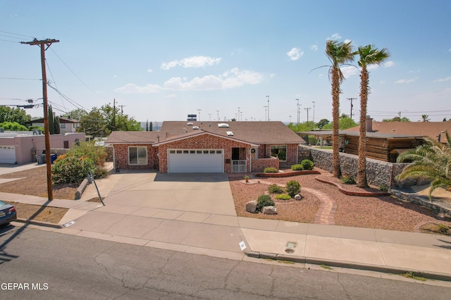 98 Northwind Dr, El Paso, TX 79912 - ranch-style home featuring an attached garage, brick siding, driveway, and a porch