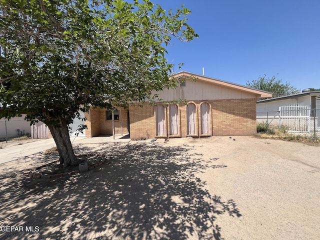733 Fall River Rd, El Paso, TX 79907 - rear view of house with fence and brick siding