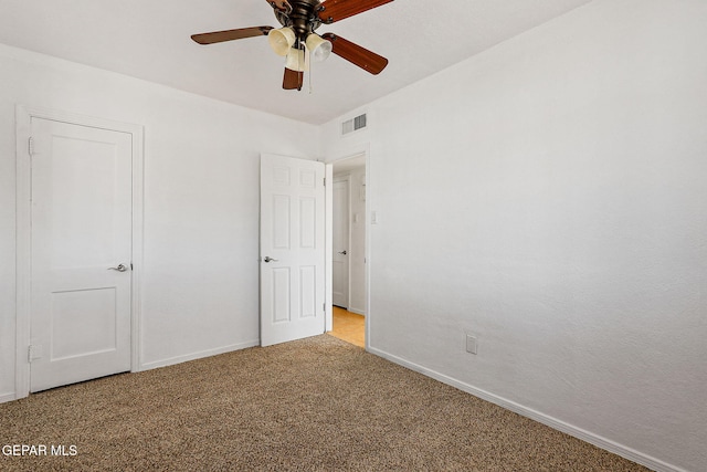 unfurnished bedroom with baseboards, light carpet, and ceiling fan