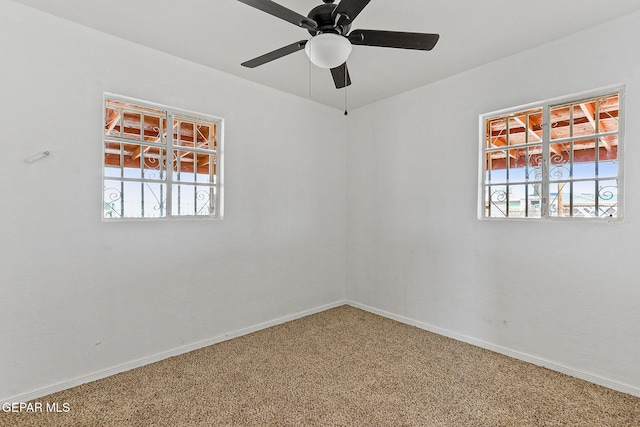 unfurnished room featuring carpet, baseboards, and ceiling fan
