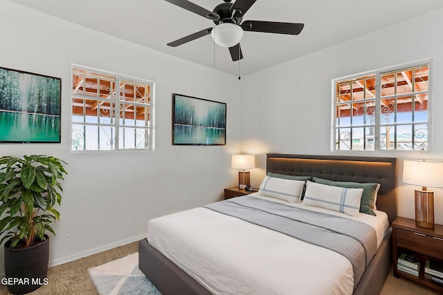 bedroom with carpet flooring, baseboards, and a ceiling fan
