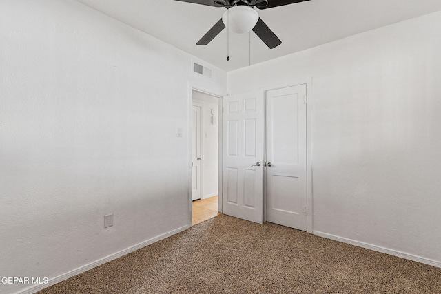 unfurnished bedroom featuring baseboards, ceiling fan, and light colored carpet