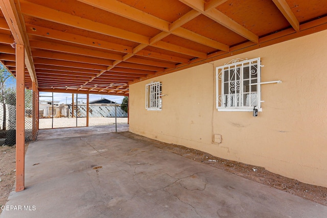 view of patio featuring fence and an attached carport