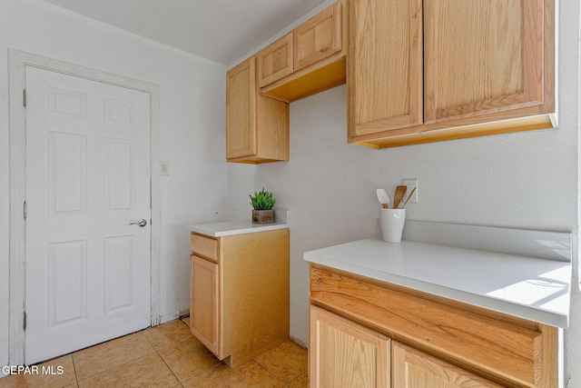 kitchen featuring light countertops, light tile patterned flooring, and light brown cabinets