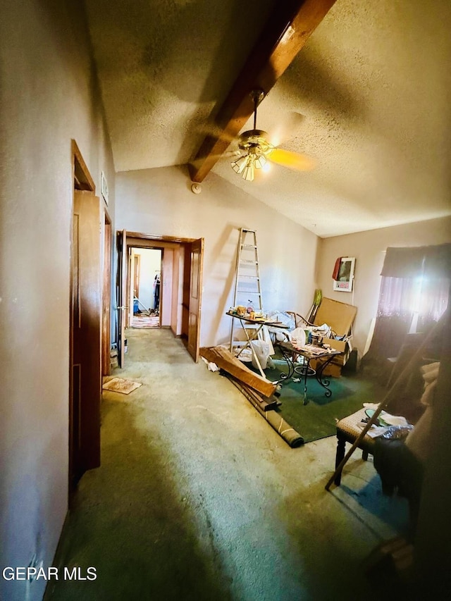 living room with a textured ceiling, a ceiling fan, and lofted ceiling with beams