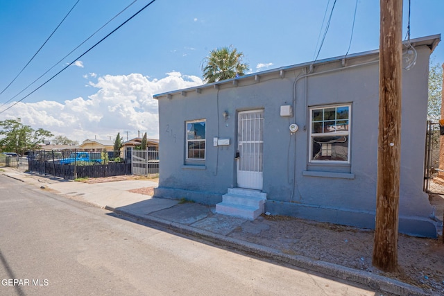 219 Dolan St, El Paso, TX 79905 - view of front of house with stucco siding, fence, and entry steps