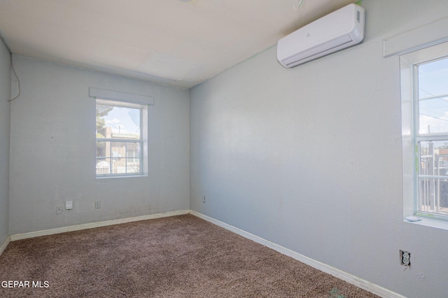 219 Dolan St, El Paso, TX 79905 - unfurnished room featuring an AC wall unit, baseboards, and carpet flooring