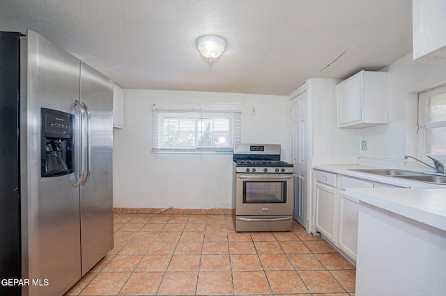 219 Dolan St, El Paso, TX 79905 - kitchen with a sink, light countertops, white cabinets, and appliances with stainless steel finishes