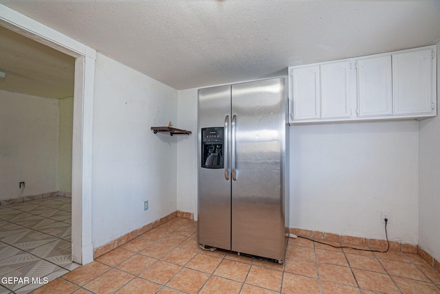 219 Dolan St, El Paso, TX 79905 - kitchen with white cabinetry, a textured ceiling, baseboards, and stainless steel refrigerator with ice dispenser