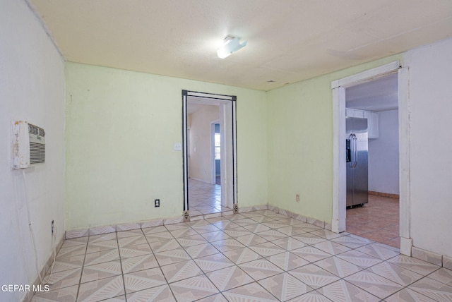 219 Dolan St, El Paso, TX 79905 - unfurnished room featuring an AC wall unit and baseboards