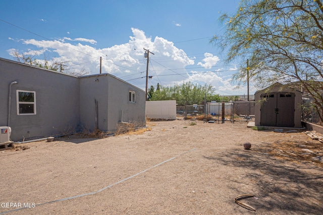 219 Dolan St, El Paso, TX 79905 - view of yard featuring a storage shed, an outdoor structure, and fence