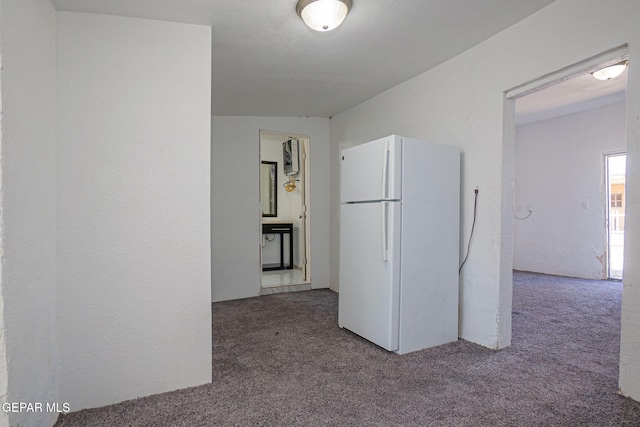 219 Dolan St, El Paso, TX 79905 - kitchen with freestanding refrigerator and carpet floors