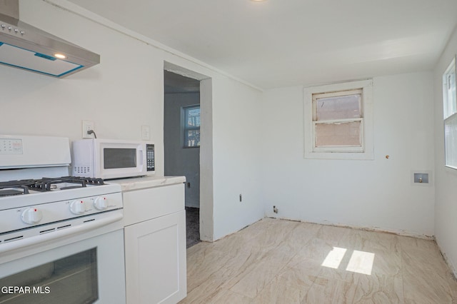 219 Dolan St, El Paso, TX 79905 - kitchen with range hood, white appliances, white cabinets, and a wealth of natural light