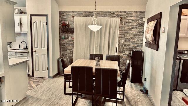 11772 Corona Crest Ave, El Paso, TX 79936 - dining area featuring light wood-style flooring and baseboards