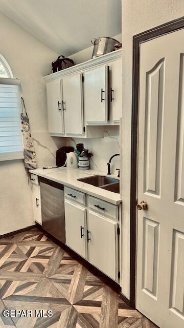 11772 Corona Crest Ave, El Paso, TX 79936 - kitchen with dishwasher, a sink, light countertops, and white cabinetry