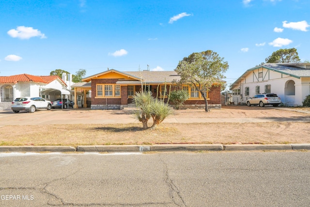 3020 Wheeling Ave, El Paso, TX 79930 - view of front of home with a detached carport, brick siding, and concrete driveway